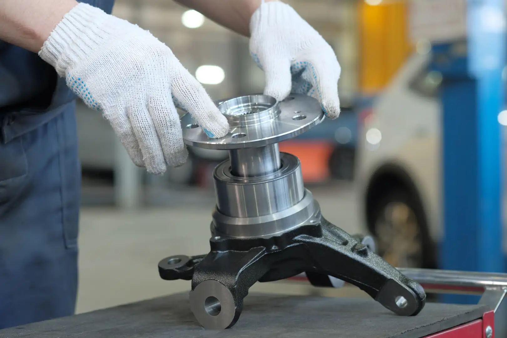 Technician fitting a wheel-hub bearing assembly